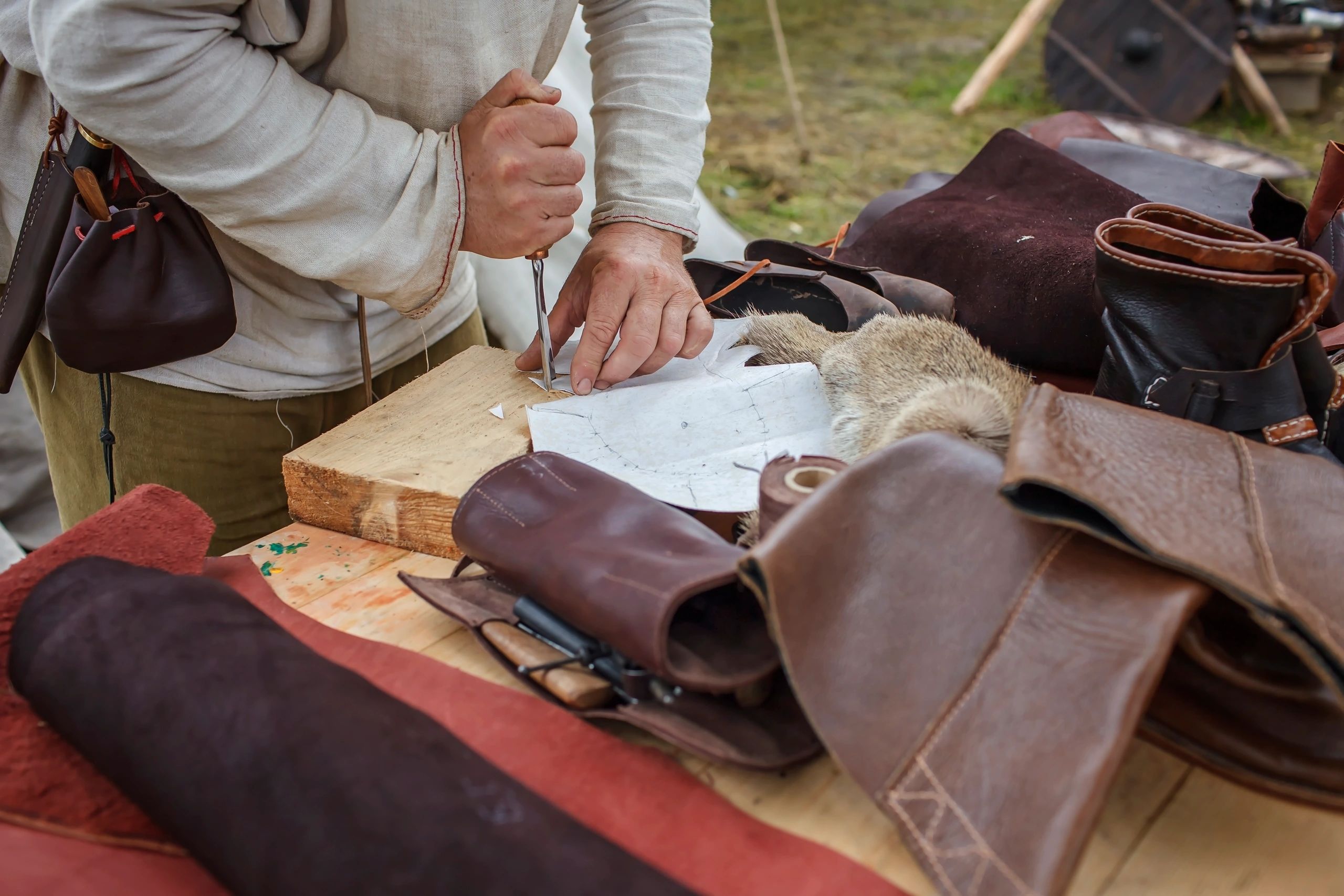Handcrafted leather footwear and tools at a medieval workshop